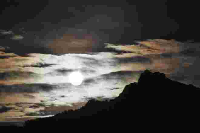 Die Silhouette des Schafbergs mit dem aufgehenden Vollmond