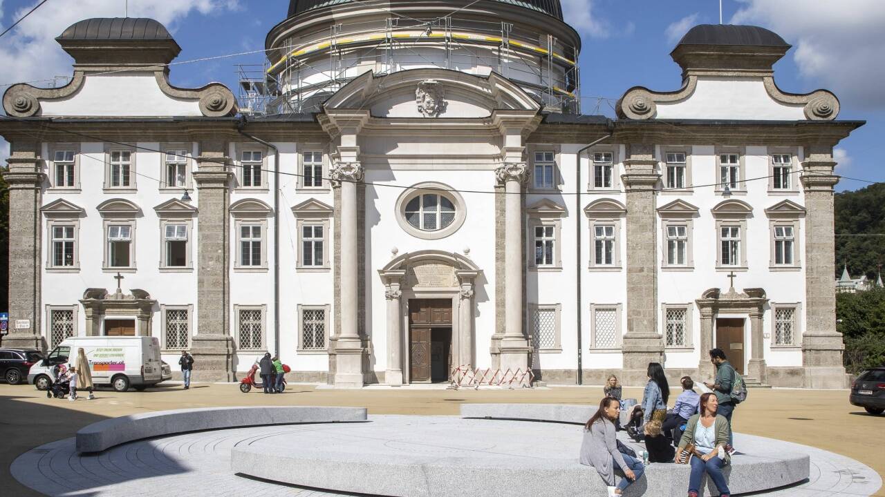 Zentrales Element auf dem neuen Kajetanerplatz ist der Brunnen mit 120 Bodendüsen und den Sitzbänken. Der gelbe Asphalt wird im Lauf der Zeit blasser.  