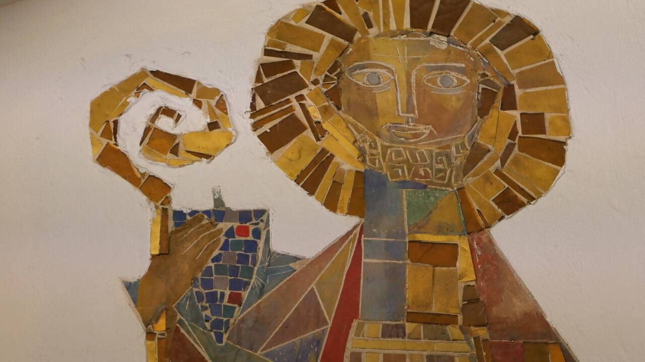 Der Heilige Rupert tritt auf diesem Wandmosaik als Weinheiliger auf.  