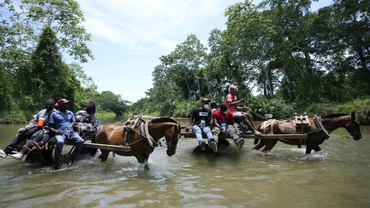Migranten überqueren den Acandí-Fluss auf ihrem Weg von Kolumbien nach Panama.  
