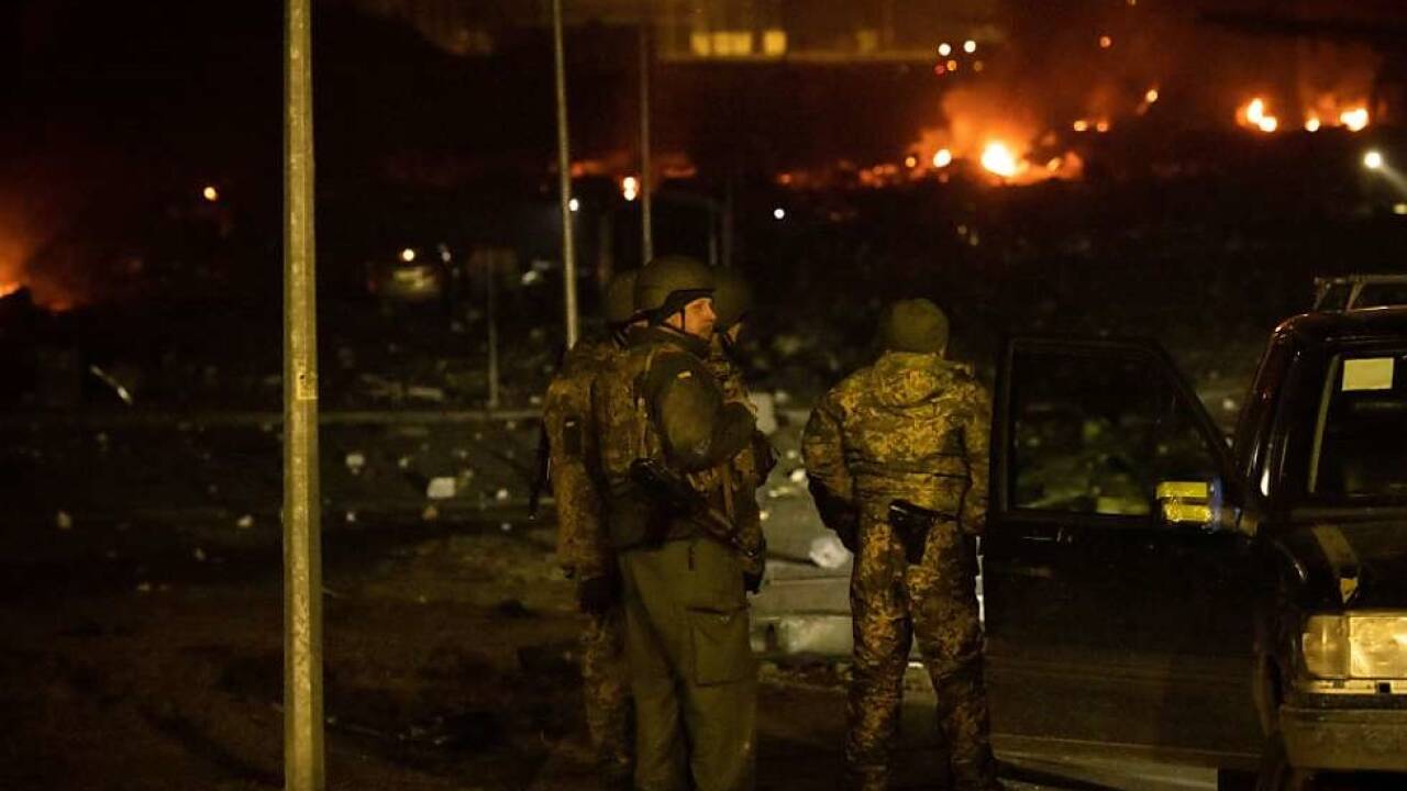 Ukrainische Polizisten blicken auf das zerstörte Einkaufszentrum  Ukrainische Polizisten blicken auf das zerstörte Einkaufszentrum