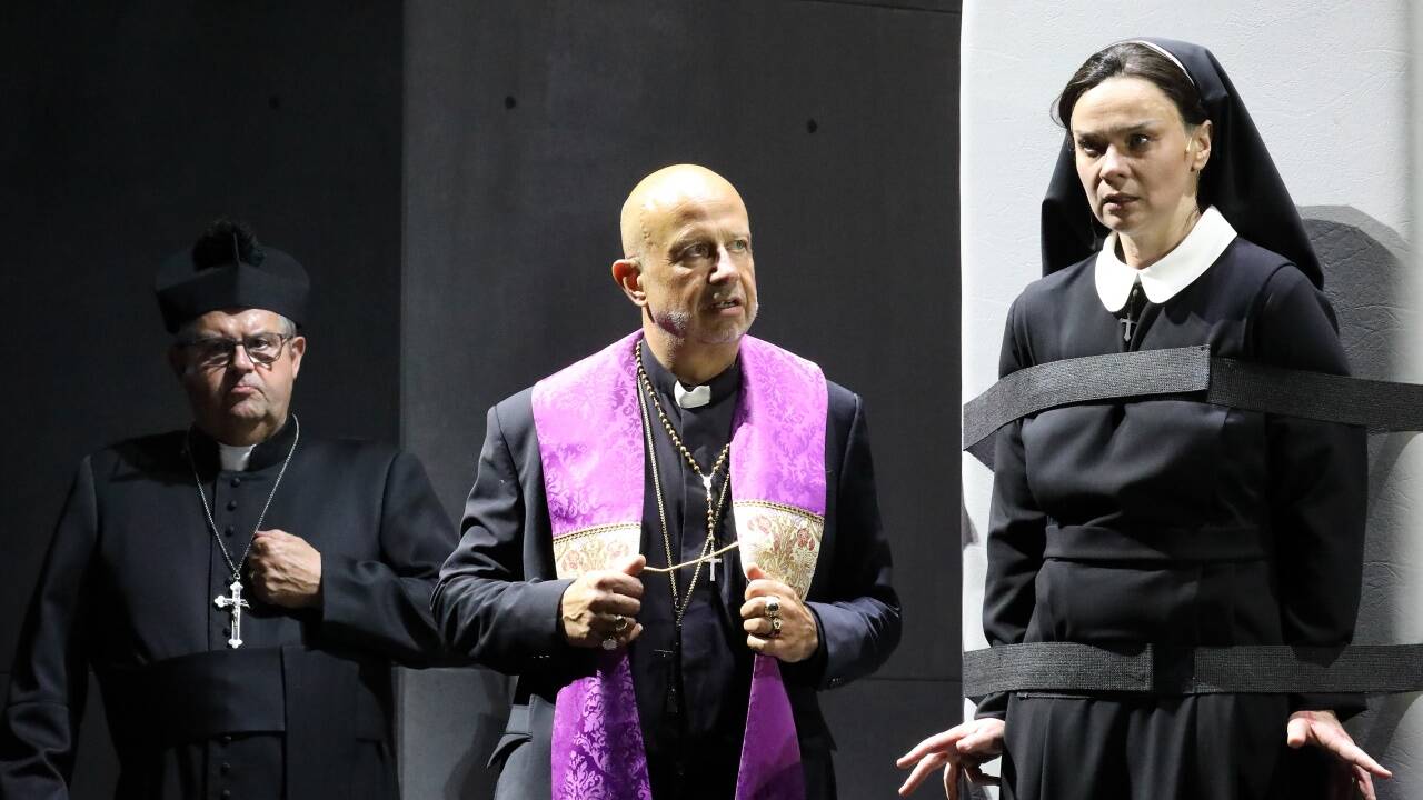 Vater Barré (Martin Winkler) nimmt die Nonne Jeanne (Ausrine Stundyte) ins Kreuzverhör. 