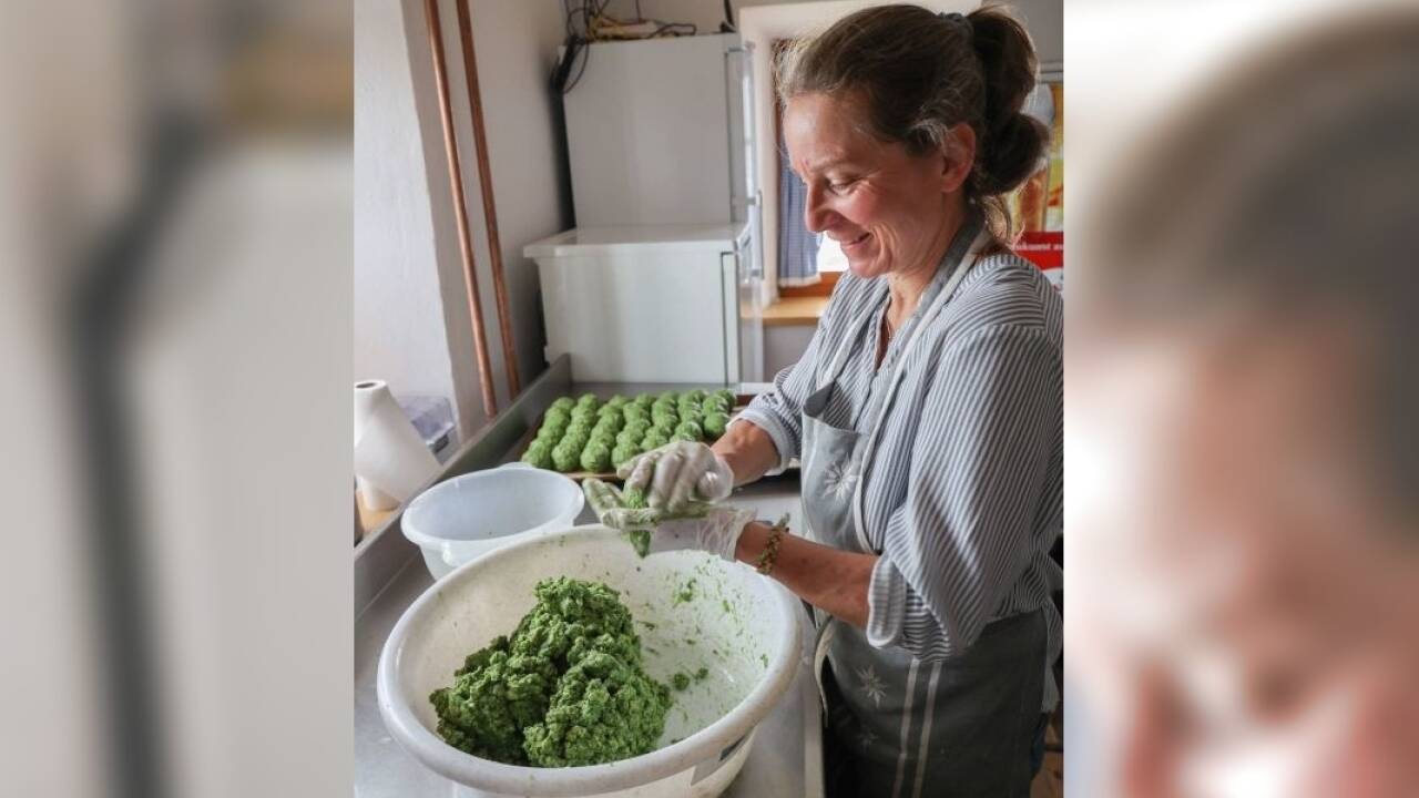 Ingrid rollt einen Knödel nach dem anderen aus der Teigmasse.  