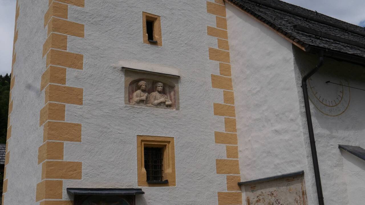 Ein Porträtstein auf dem Kirchturm in St. Martin im Lungau. 