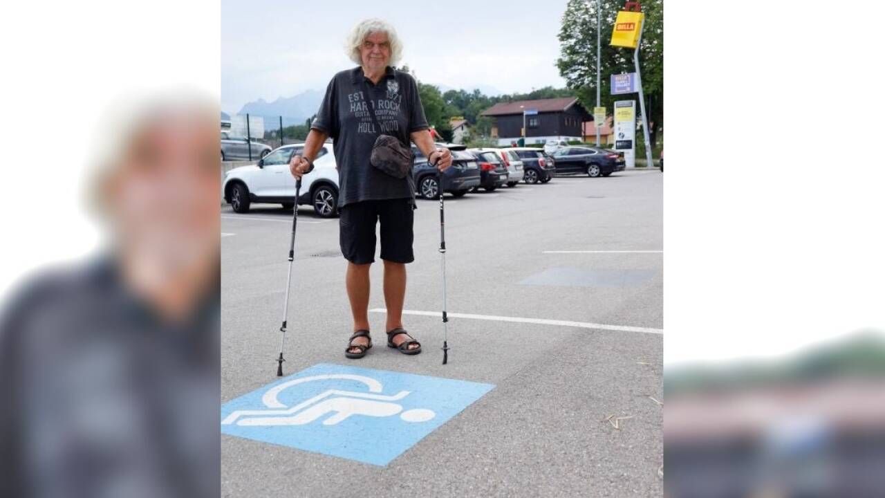 Peter Schatz vor einem Behindertenparkplatz.  Peter Schatz vor einem Behindertenparkplatz.