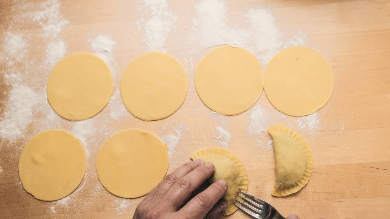 Die gefüllten Teigtaschen zusammenklappen und kochen lassen. 