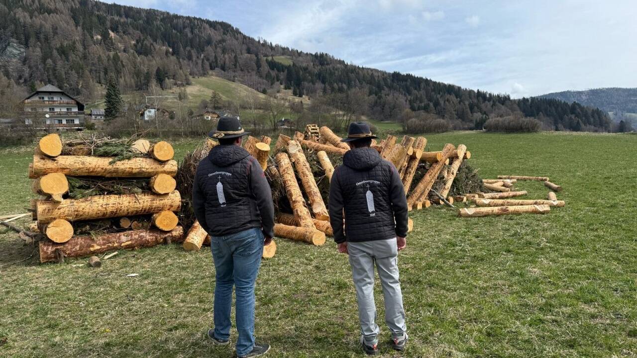 Mitglieder der Brauchtumsgruppe Höf bei St. Michael vor ihrem umgestoßenen Osterfeuer.   Mitglieder der Brauchtumsgruppe Höf bei St. Michael vor ihrem umgestoßenen Osterfeuer.