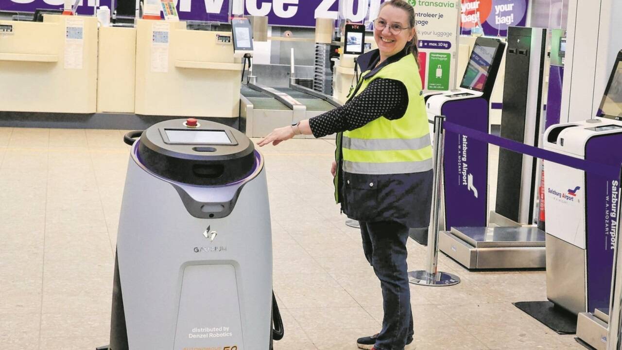 Claudia Amerijan mit einem Wischroboter im Check-in-Bereich des Salzburger Flughafens.   Claudia Amerijan mit einem Wischroboter im Check-in-Bereich des Salzburger Flughafens.