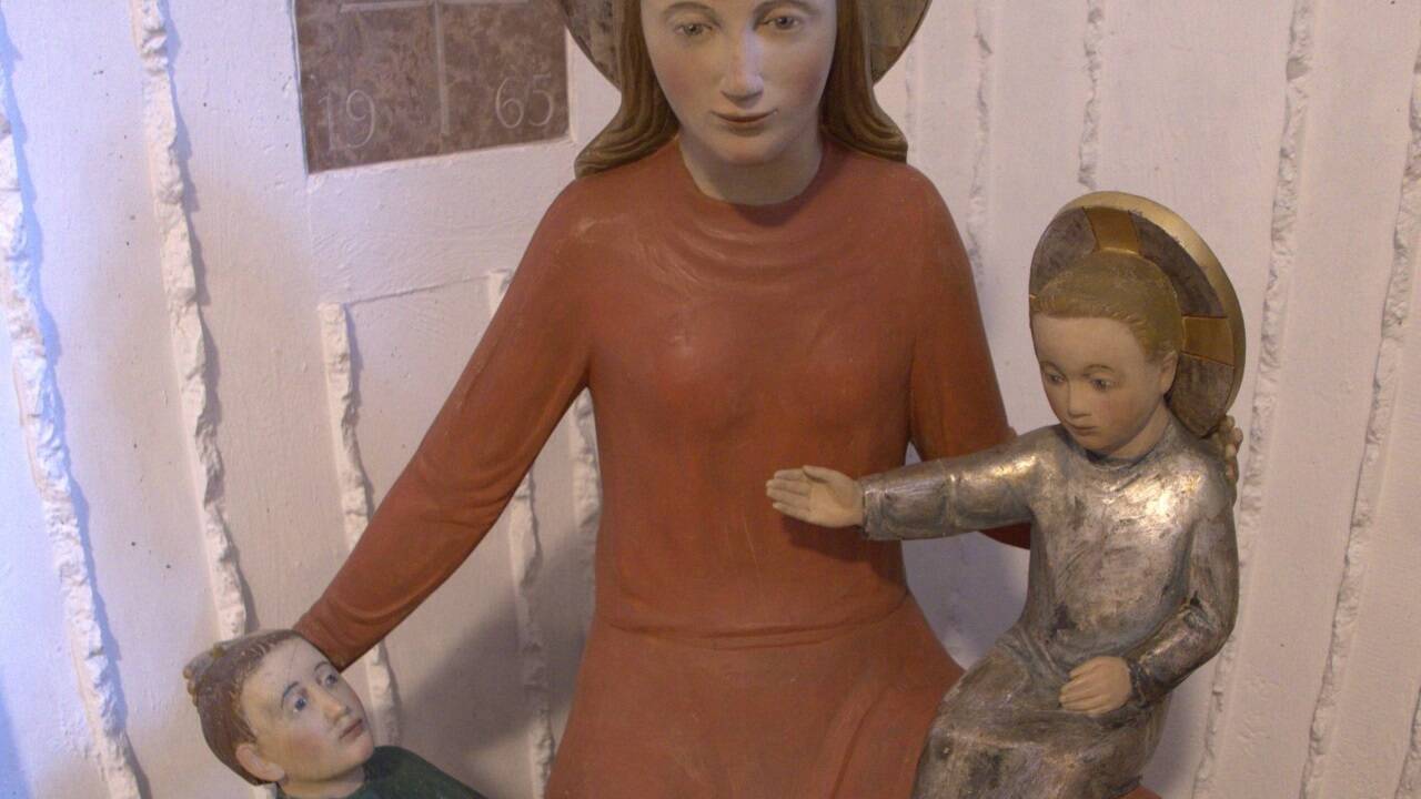 Ein starker Farbkontrast zwischen Rot und Grün prägt die Skulptur.  
