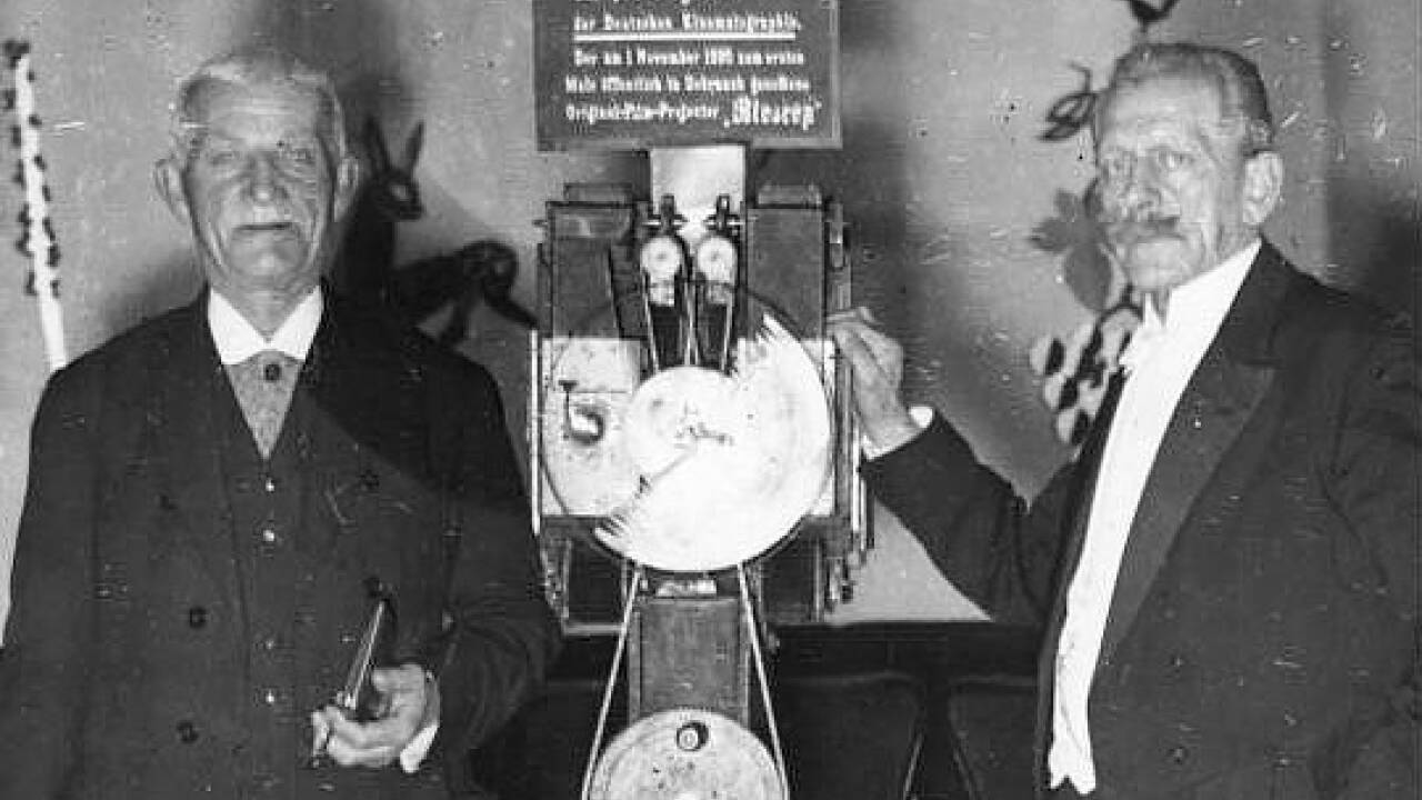 1895: Die Brüder Max (rechts) und Emil Skladanowsky führen im Berliner Wintergarten erstmals „lebende Bilder“ vor – ein Meilenstein der Filmgeschichte. Sie benützen ein Bioskop, das mit zwei Projektoren und zwei Filmstreifen arbeitet. 