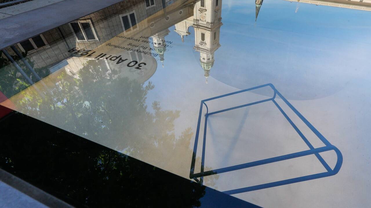 Hinter Glas ist das Skelett eines Buches sichtbar.  