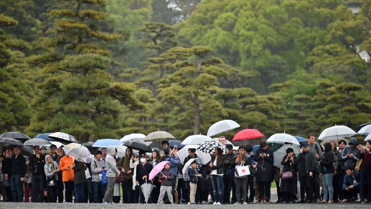 Die Öffentlichkeit war von der Zeremonie zwar ausgeschlossen, viele Japaner kamen aber dennoch in der Nähe des Kaiserpalasts zusammen. Das Wetter präsentierte sich allerdings wie hierzulande von seiner nassen Seite. 