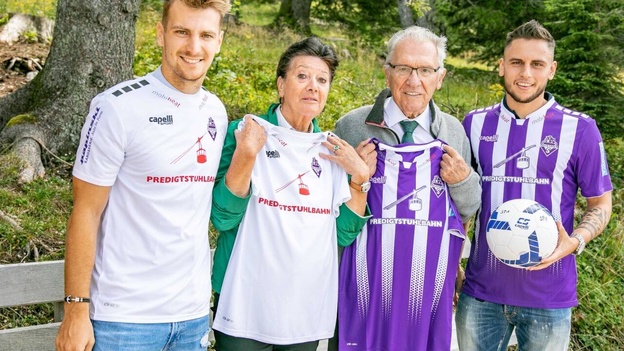 Die Austria-Spieler Marco Hödl (l.) und Umberto Gruber (r.) präsentieren mit Max und Evelyn Aicher die neuen Trikots.  