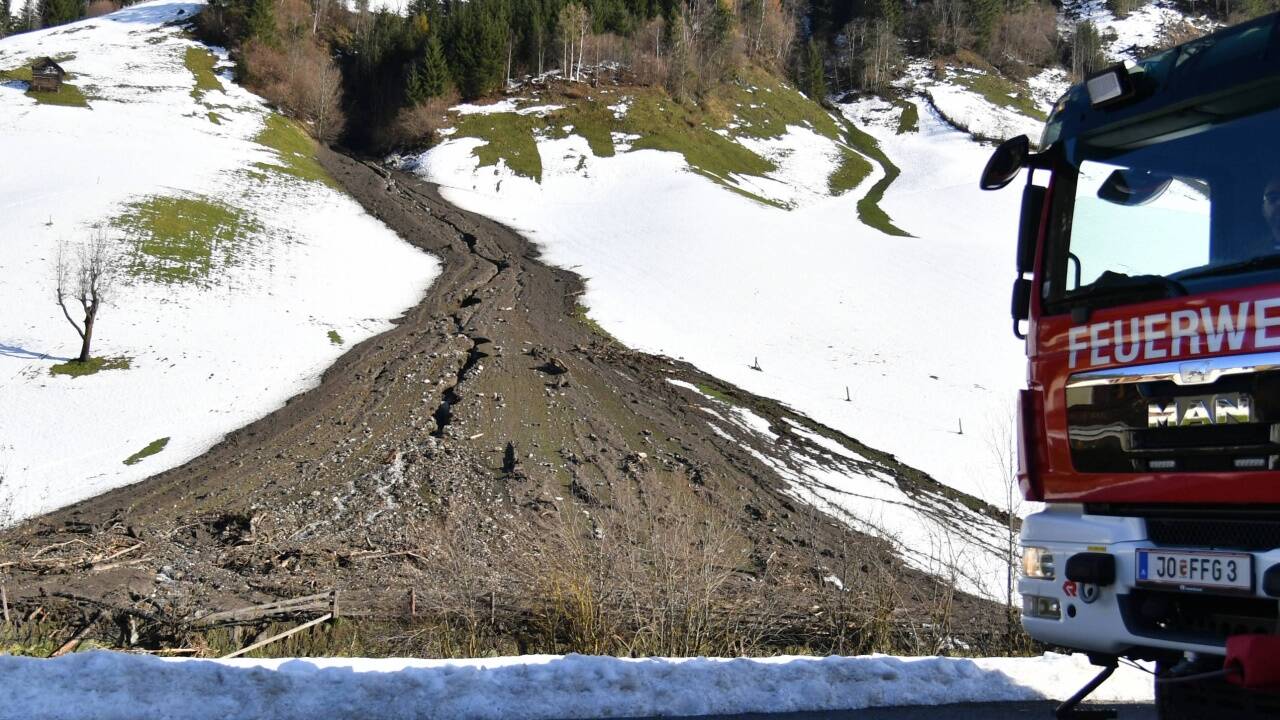 Ein Feuerwehrauto steht am Montag an einem der Murenabgänge auf der Strecke zwischen Großarl und Hüttschlag.  