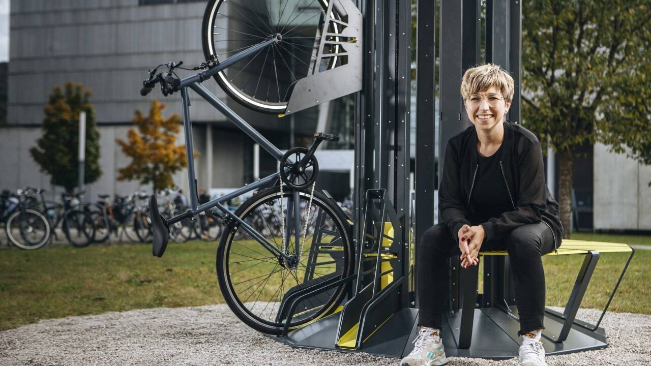 Tanja Friedrich und der Prototyp von Bikeparker, der vor der FH Salzburg steht. 