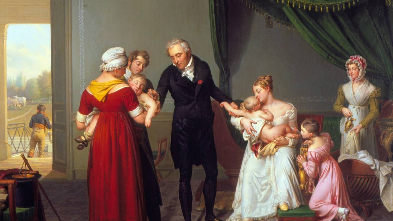 Der Maler Constant-Joseph Desbordes (1761–1827) hielt diese Szene fest: Baron Jean Louis Alibert (1768-1837), bedeutender Dermatologe und Arzt des französischen Königs Ludwig XVIII., führt um 1820 im Château de Liancourt bei Paris die Impfung gegen die Pocken durch.  