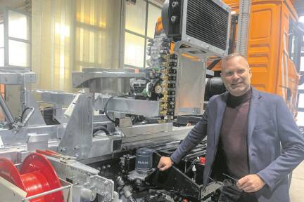 Geschäftsführer Stephan Trilety mit einem Fahrzeug, das sich gerade im Aufbau befindet. 