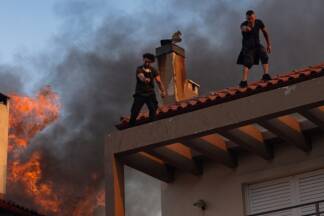 Flammen breiten sich auf Wohngebiet aus. Bewohner in Kryoneri fliehen aus ihren Häusern. Flammen breiten sich auf Wohngebiet aus. Bewohner in Kryoneri fliehen aus ihren Häusern.
