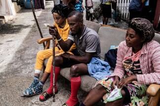 People with minor injuries sit outside in the aftermath of Hurricane Melissa, in Petit-Goave, about 68 km (42 miles) southwest of Port-au-Prince, on October 31, 2025. In Haiti, the country's civil defense agency said on October 30 that the death toll from Hurricane Melissa had risen to 30, with 20 people injured and another 20 missing. (Photo by Clarens SIFFROY / AFP)  People with minor injuries sit outside in the aftermath of Hurricane Melissa, in Petit-Goave, about 68 km (42 miles) southwest of Port-au-Prince, on October 31, 2025. In Haiti, the country's civil defense agency said on October 30 that the death toll from Hurricane Melissa had risen to 30, with 20 people injured and another 20 missing. (Photo by Clarens SIFFROY / AFP)