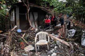 People look on as piles of debris lie beside a damaged house in the aftermath of Hurricane Melissa, in Petit-Goave, about 68 km (42 miles) southwest of Port-au-Prince, on October 31, 2025. In Haiti, the country's civil defense agency said on October 30 that the death toll from Hurricane Melissa had risen to 30, with 20 people injured and another 20 missing. (Photo by Clarens SIFFROY / AFP)  People look on as piles of debris lie beside a damaged house in the aftermath of Hurricane Melissa, in Petit-Goave, about 68 km (42 miles) southwest of Port-au-Prince, on October 31, 2025. In Haiti, the country's civil defense agency said on October 30 that the death toll from Hurricane Melissa had risen to 30, with 20 people injured and another 20 missing. (Photo by Clarens SIFFROY / AFP)